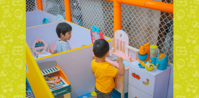 Two children at pretend play stations