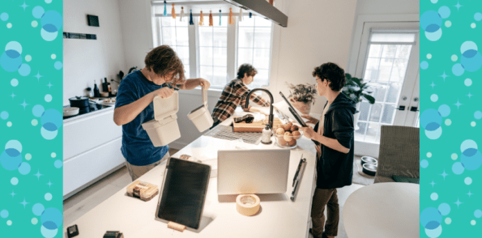 Three teenage boys cleaning in the kitchen